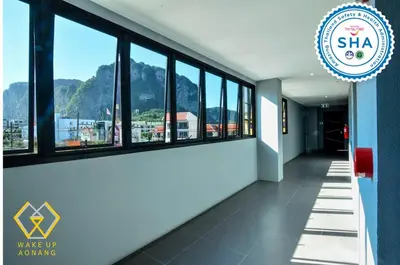 a hallway with windows and a sign that says wake up knowing at Wake Up Aonang Hotel in Ao Nang Beach