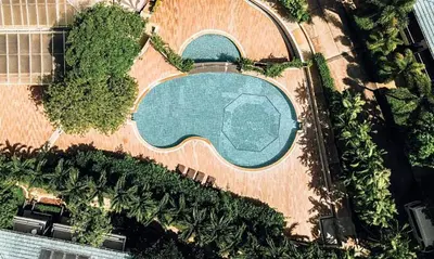 an overhead view of a swimming pool with trees at Wake Up Aonang Hotel in Ao Nang Beach