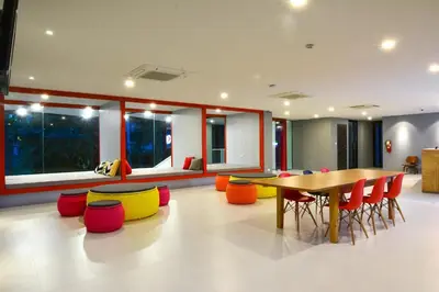 a dining room with a table and colorful chairs at Wake Up Aonang Hotel in Ao Nang Beach