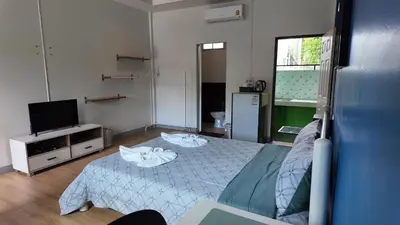 a bedroom with a bed and a flat screen tv at Vii House Rawai Phuket in Rawai Beach