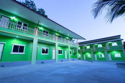 an exterior view of a green building at Vii House Rawai Phuket in Rawai Beach