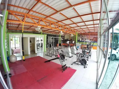 a gym with a lot of exercise equipment in it at Vii House Rawai Phuket in Rawai Beach