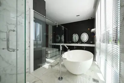 a bathroom with a large tub and a glass shower at Glam Habitat - SHA Extra Plus in Kamala Beach