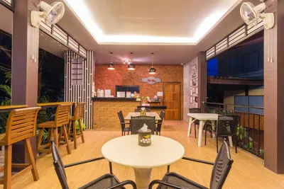 a restaurant with tables and chairs in a room at Fantasy Hill Bungalow in Kata Beach