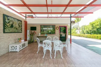 a patio with white chairs and a table at Chaiyo Resort in Phuket Town