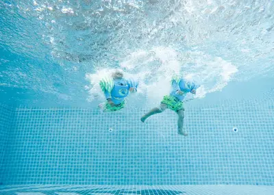 two people in the water in a swimming pool at Panphuree Residence in Nai Yang Beach