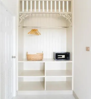 a walk in pantry with white shelves and a toaster at Panphuree Residence in Nai Yang Beach