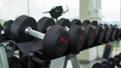 a row of dumbbells on a rack in a gym at Panphuree Residence in Nai Yang Beach