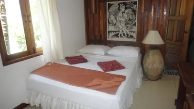 a bedroom with two beds and a lamp at Tropical Garden Bungalow in Phi Phi Don