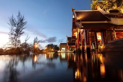 a flooded street next to a building at night at Maikhao Palm Beach Resort - SHA Plus in Mai Khao Beach