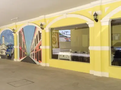 a yellow building with a mural of a bridge at Phuket Chinoinn-SHAPlus Certified in Phuket Town