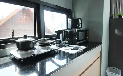 a kitchen with two pots and pans on a counter at Unique Loft Apartment in Kamala Beach