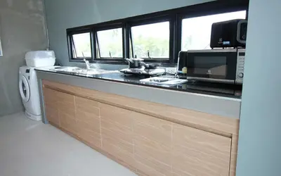 a kitchen with a counter with a microwave and a sink at Unique Loft Apartment in Kamala Beach