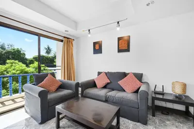 a living room with a couch and a table at The Club Residence Kamala Beach in Kamala Beach
