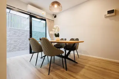 a dining room with a table and chairs at T House in Bang Tao Beach
