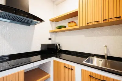 a kitchen with a sink and a microwave at T House in Bang Tao Beach
