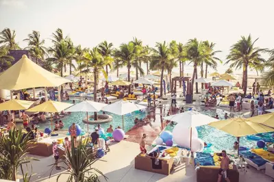 a group of people at a resort swimming pool at T House in Bang Tao Beach