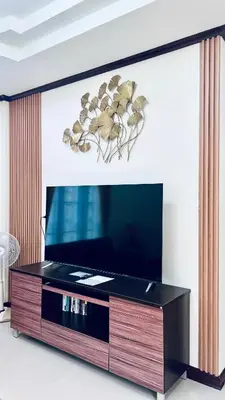 a living room with a flat screen tv at Malinee Villa Phuket in Bang Tao Beach