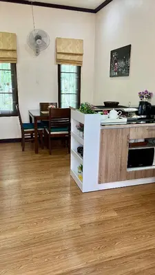 a kitchen and dining room with a table and a counter at Malinee Villa Phuket in Bang Tao Beach
