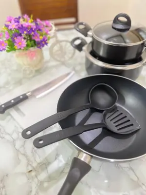 a frying pan with two spoons on a counter at Malinee Villa Phuket in Bang Tao Beach