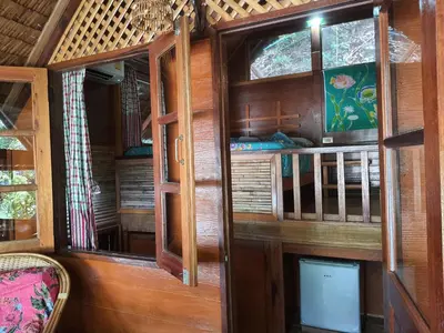 an inside view of a room with wooden walls and windows at Sabai Corner Bungalows - SHA Extra Plus in Ko Yao Noi