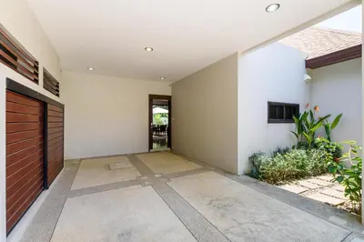 an empty hallway of a house with a door at Inspire Villas Phuket in Rawai Beach
