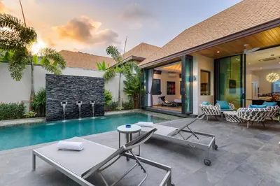 a villa with a swimming pool and a house at Inspire Villas Phuket in Rawai Beach