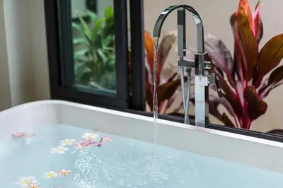 a sink with water coming out of a faucet at Inspire Villas Phuket in Rawai Beach