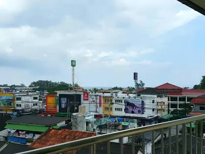 a view of a city from a balcony at Thira House in Karon Beach