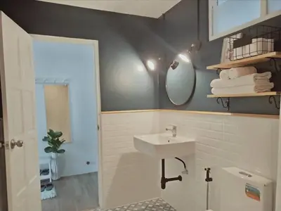 a bathroom with a sink and a mirror at Thira House in Karon Beach