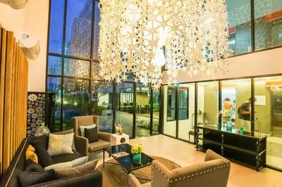 a large room with couches and a chandelier at Centrio nearby Central Phuket in Phuket Town