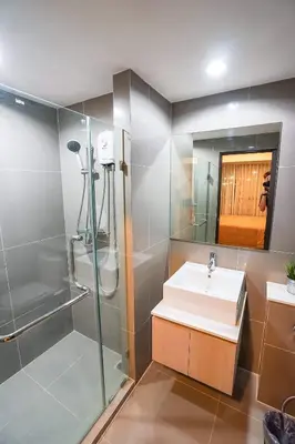 a bathroom with a sink and a shower and a mirror at Centrio nearby Central Phuket in Phuket Town