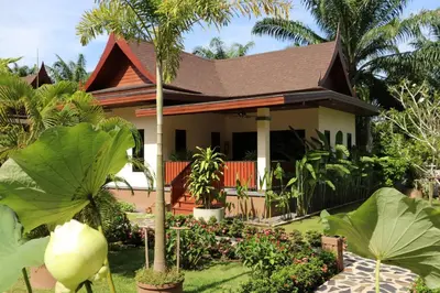 a house with a garden in front of it at Chanapha Residence in Tab Kaek Beach