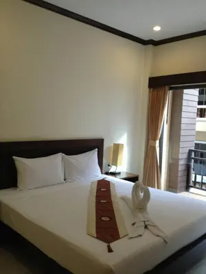 a bedroom with a bed with a tie on it at Baan Kingkeaw Thamdee Patong in Patong Beach