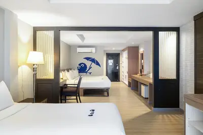 a hotel room with a bed and a bathroom at Kokotel Phuket Patong in Patong Beach