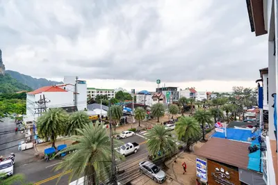 a city with palm trees and a street with cars at Kokotel Krabi Ao Nang in Ao Nang Beach