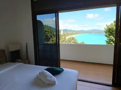 a bedroom with a bed and a view of the ocean at On The Hill Karon Resort in Karon Beach
