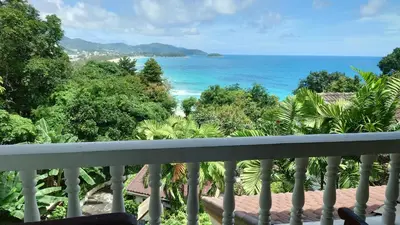 a view of the ocean from a balcony at On The Hill Karon Resort in Karon Beach