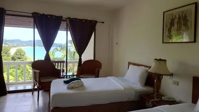 a hotel room with two beds and a balcony at On The Hill Karon Resort in Karon Beach