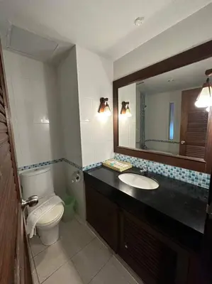 a bathroom with a toilet and a sink and a mirror at Baan Yuree Resort & Spa - SHA Plus in Patong Beach