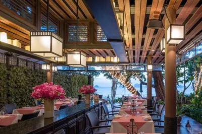 a restaurant with tables with pink flowers on them at The Tubkaak Krabi Boutique Resort in Tab Kaek Beach