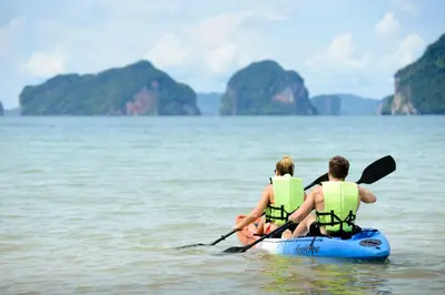 two people are in a kayak in the water at The Tubkaak Krabi Boutique Resort in Tab Kaek Beach