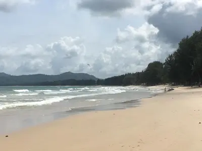 a beach with a kite flying over the ocean at Surin villa in Surin Beach