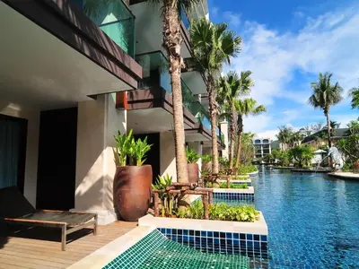 a resort with a swimming pool and palm trees at Phuket Graceland Resort and Spa in Patong Beach