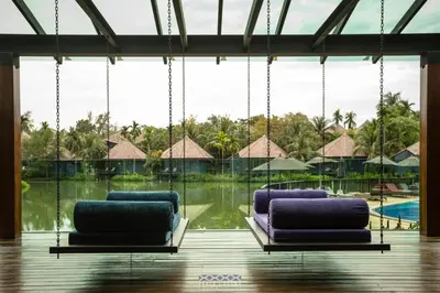 two purple chairs sitting in front of a pool at Peace Laguna Resort & Spa in Ao Nang Beach