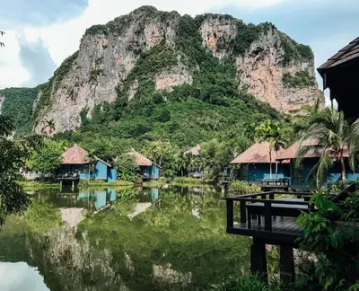 a mountain and some houses and a body of water at Peace Laguna Resort & Spa in Ao Nang Beach
