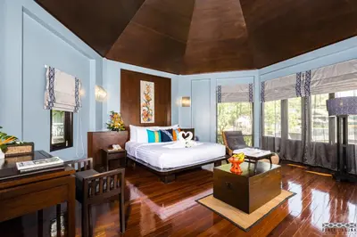 a bedroom with a bed and a desk in a room at Peace Laguna Resort & Spa in Ao Nang Beach
