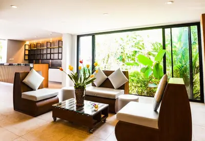 a living room with a couch and chairs and a table at Ramada by Wyndham Aonang Krabi in Ao Nang Beach
