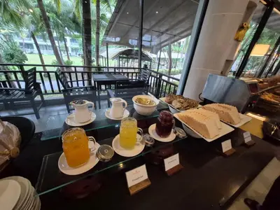 a table with breakfast foods and drinks on it at Ramada by Wyndham Aonang Krabi in Ao Nang Beach