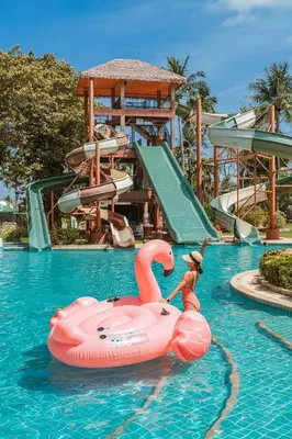 a person in a pink raft in the water at a water park at Thavorn Palm Beach Resort Phuket in Karon Beach
